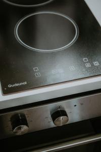 a close up of a stove with a control panel at L'éléhouse Studio Terrasse à RIOM in Riom