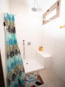 a bathroom with a shower curtain and a sink at כפר הצוללים in Eilat