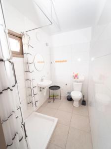 a white bathroom with a toilet and a sink at כפר הצוללים in Eilat