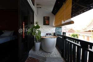 a balcony with a tub and a plant on it at BlueHome in Vientiane +1 photo