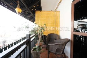 a balcony with two chairs and a window at BlueHome in Vientiane