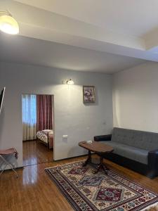 a living room with a couch and a table at Yeghevnut Hotel in Goris