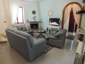 a living room with two couches and a tv at Villa Dafne mare Fondi Sperlonga in Fondi