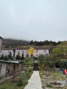 a stairway leading up to a building with a house at Yeghevnut Hotel in Goris
