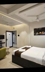 a bedroom with a large bed in a room at Lotus Excutive in Pune