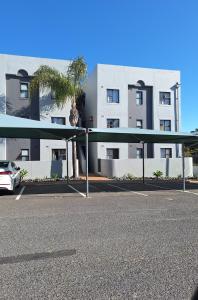 a parking lot in front of a building at Serengeti Heide Self Catering Flats in Cape Town
