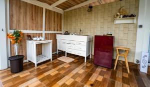 a kitchen with white cabinets and a red refrigerator at The River Island Sidemen in Sidemen +95 photos