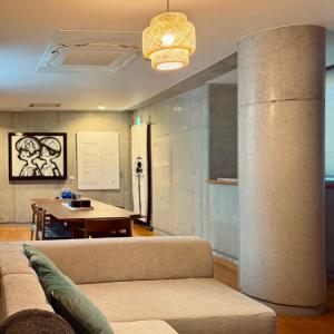a living room with a couch and a table at Shiki Art Hotel Yufu in Yufu +258 photos