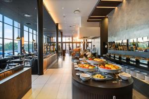 a buffet line with bowls of food in a restaurant at The Capital Mbombela in Nelspruit