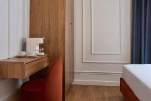 a room with a desk and a chair and a bed at Athens Icon Collection in Athens