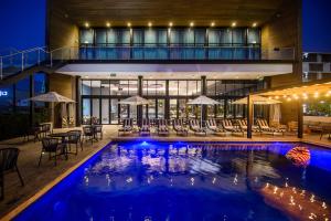 a swimming pool in the middle of a house at night at The Capital Mbombela in Nelspruit +48 photos