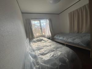 Postel nebo postele na pokoji v ubytování 白馬樹海