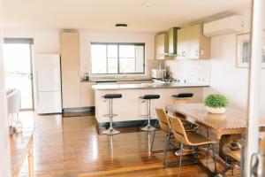 a kitchen with a wooden table and a wooden floor at Kings at Tower Hill in Illowa +13 photos