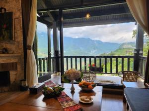 a room with a table with a view of a mountain at Heaven House Sapa in Sapa