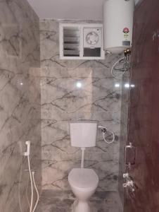 une salle de bain avec toilettes et douche dans l'établissement Msquare guest room, à Godāvari