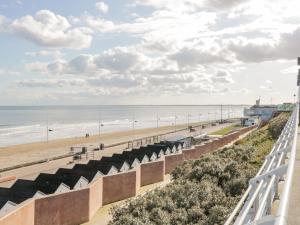 a view of the beach from the balcony of a beach house at Apt 5 Hunter's Quay in Bridlington