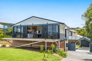 a house with a wrap around porch with glass at Ocean Moore - Uninterrupted Ocean Views in Guilderton