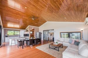 a living room with a white couch and a wooden ceiling at Ocean Moore - Uninterrupted Ocean Views in Guilderton