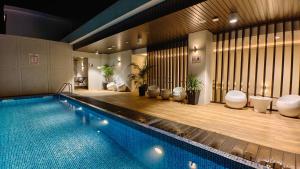 a swimming pool in a building with a pool at Hotel Warisan in Taiping
