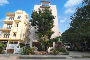 a tall building with a tree in front of it at Collection O Biswa Bangla Convention Centre Kolkata Formerly Atithya Inn in New Town +30 photos