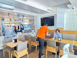 a man and a child sitting at a table in a restaurant at Ripple Beach Inn in Hulhumale +74 photos