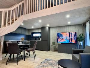 a living room with a tv and a table and chairs at PUTNI Resort in Laukbeitini