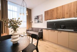 a kitchen with a table with a vase of flowers at Apartmány Ružomberok in Ružomberok +60 photos