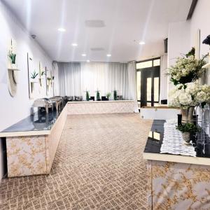 a salon with flowers on display in a room at Bloom Hotel-Kuwait in Kuwait
