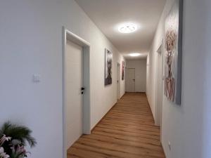 a hallway with white walls and wooden floors at Villa Last Chance, Brač in Povlja
