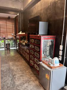 a kitchen with a red stove and some food at Villa Thapae in Chiang Mai