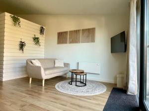 a living room with a couch and a table at Farmhouse Bintje met Airco in Westdorpe