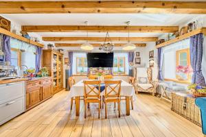 a kitchen and dining room with a table and chairs at Chaloupka Ovčárna in Jindrichuv Hradec
