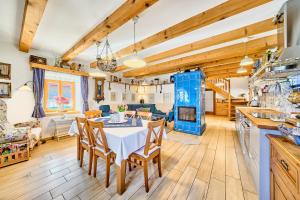 a kitchen and dining room with a table and chairs at Chaloupka Ovčárna in Jindrichuv Hradec