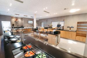 a large kitchen with a buffet line in a restaurant at Eco Suite Hotel in Salzburg