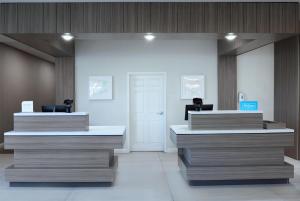 a lobby with two reception desks in a building at Hilton Garden Inn Grand Forks-Und in Grand Forks