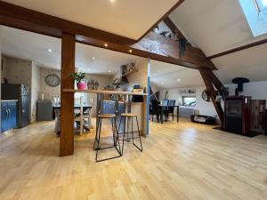 a living room with a kitchen and a dining room at Grand Triplex 140m2 dans les Vosges in La Celle-sous-Gouzon +47 photos