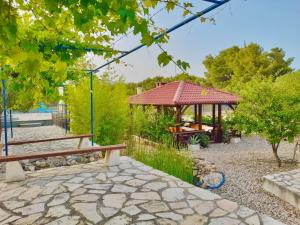 a park with a bench and a gazebo at Villa Last Chance, Brač in Povlja