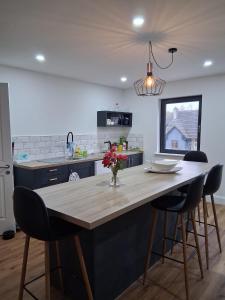 a kitchen with a table with chairs and a counter top at Railway House, Halfway in Ballinhassig