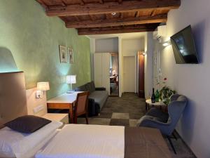 a hotel room with a bed and a living room at The Golden Wheel Hotel in Prague