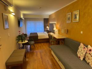 a hotel room with a couch and a bed at The Golden Wheel Hotel in Prague