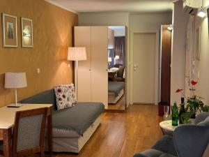 a living room with a couch and a table at The Golden Wheel Hotel in Prague +26 photos