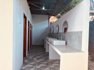 a bathroom with sinks and mirrors on the wall at Nongkhiaw IngIng Backpackers Hostel in Nongkhiaw +11 photos