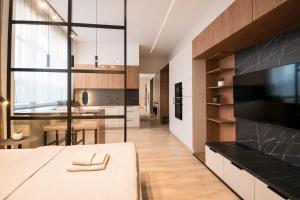 a kitchen with a large window and a dining room at Apartmány Ružomberok in Ružomberok