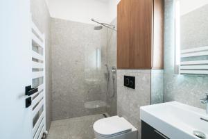a bathroom with a shower and a toilet and a sink at Apartmány Ružomberok in Ružomberok