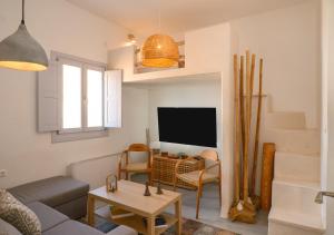 a living room with a couch and a tv at GiSt in Livadi Astypalaias