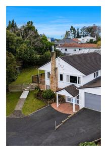 an aerial view of a white house with a driveway at Rest & Relax Holiday Home in Whangarei