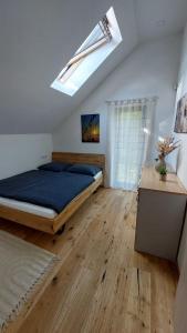a bedroom with a large bed and a skylight at Apartmán u Dolní Moravy in Prostřední Lipka