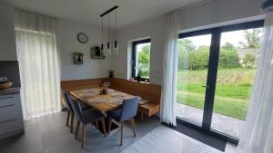 a dining room with a table and chairs and a window at Apartmán u Dolní Moravy in Prostřední Lipka