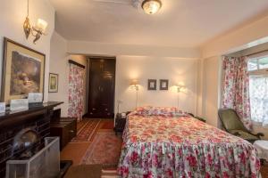a hotel room with a bed and a fireplace at Windamere Hotel - A Colonial Heritage Since 1841 in Darjeeling