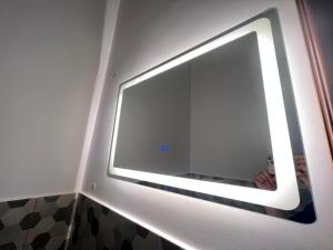 a mirror in a bathroom with a person taking a picture at Bianca B&B in Ardea